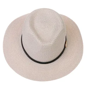 Detailed top view of a woven straw hat featuring a black band and wooden buckle