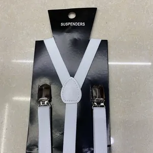 Close-up of white Y-back elastic suspenders with silver metal clips on a display card