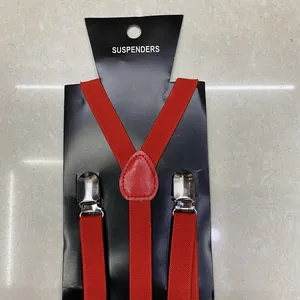 Detail view of red Y-back elastic suspenders with silver metal clips and leather joint