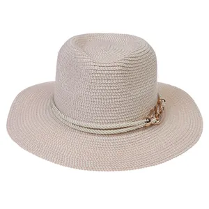 Detail of light beige straw sun hat featuring a double white cord and gold chain accent