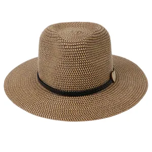 Close-up of woven straw hat texture with heart wooden charm and black decorative cord