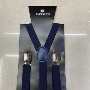 Detail of dark blue elastic suspenders with silver metal clips on a display card