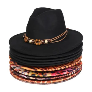 Detail of stacked wool fedora hats with bohemian beaded band and leopard print brims