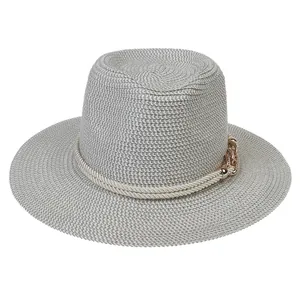 Detail of grey straw Panama hat featuring decorative hemp rope and gold metal chain buckle