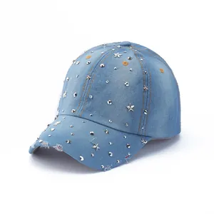 Close-up of light blue denim baseball cap with silver star studs and frayed vintage brim