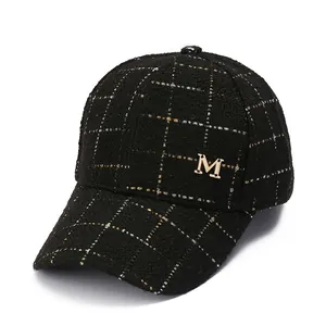 Winter black tweed baseball cap with gold plaid pattern and metallic M logo accent