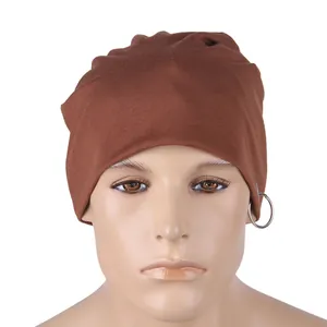 Detail of dark brown knitted beanie with silver metal ring on white background