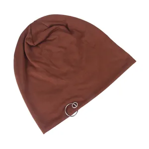 Detail view of a brown knit beanie with double silver metal ring decorative accents