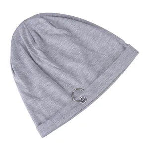 Detail of light gray beanie featuring double silver metal rings on a ribbed cotton fabric