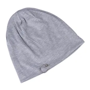 Detail of light gray cotton beanie featuring a silver metal ring accent on white background