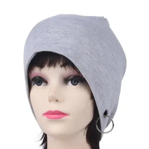 Detail of light gray beanie featuring a decorative silver metal ring and seamless hem