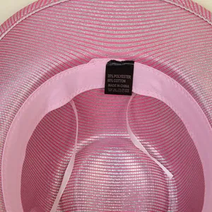 Detail of pink and silver cowboy hat interior showing the cotton fabric sweatband and labels