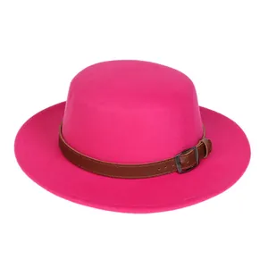 Detail of rose red felt fedora hat featuring a brown leather band and metallic buckle