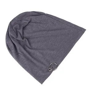 Detail of dark grey beanie with decorative metal ring on soft jersey fabric