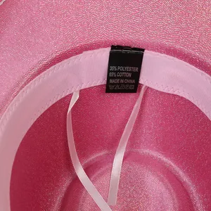 Detail of pink sequin cowboy hat interior showing 65% cotton fabric label and sweatband