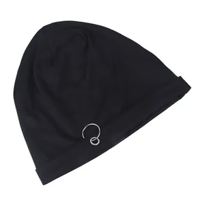 Close-up of black knitted beanie featuring two interlocking metal rings for hip hop style