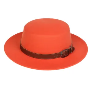 Detail of bright orange wool felt fedora with a dark brown leather band and metal buckle