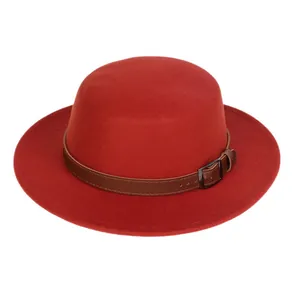 Detail of red wool felt hat with brown faux leather strap and metal buckle accent