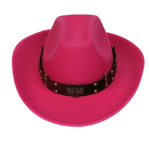 Close-up of pink felt cowboy hat with eagle emblem and metal stud detailing