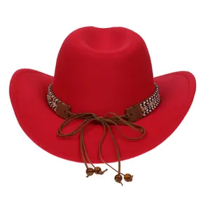 Detail of red cowboy hat with woven decorative band and small wooden beads on white background