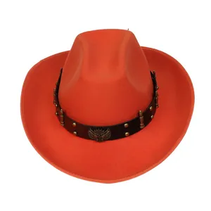 Detail of orange cowboy hat with black leather band, gold rivets and metallic eagle badge
