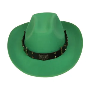 Detail of green felt cowboy hat with decorative owl emblem and metal bullet studs
