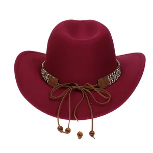 Detail of burgundy western cowboy hat featuring ethnic woven band and wooden beads