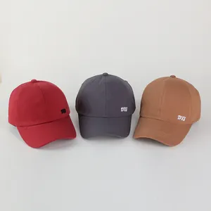 Detailed side view of baseball caps in red, charcoal and brown with DYJ embroidery