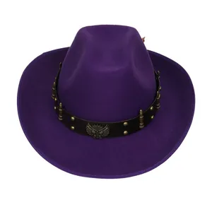 Detail of purple felt cowboy hat featuring eagle metal emblem and bullet studs on band