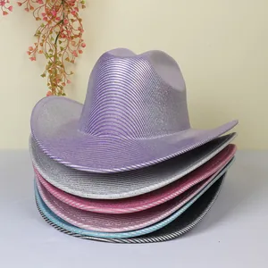 Close-up of stacked colorful western cowboy hats with metallic glitter stripes texture