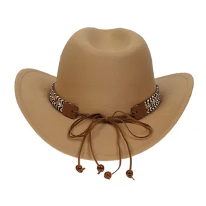 Detail of khaki denim cowboy hat with ethnic woven band and wooden bead decoration
