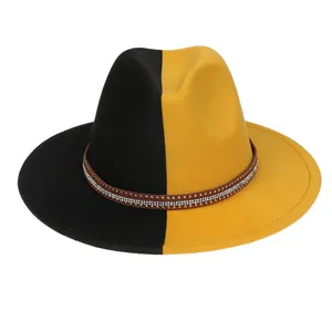 Close-up of dual-tone fedora hat showing brown band with rhinestones and rivets details