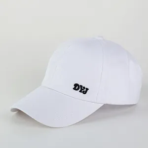 Detail of white cotton ponytail sun hat featuring black DYJ embroidery on the side