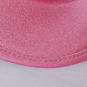 Macro detail of pink glitter sequins and fine stitching on a western cowboy hat brim