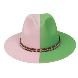 Detail of two-tone pink and green wool fedora hat with studded leather band decoration