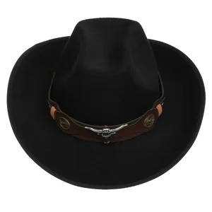 Detail of black wool cowboy hat with leather band and silver bull head metal ornament