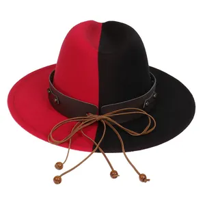 Detail of red and black felt fedora with leather band, studs and hanging wooden beads
