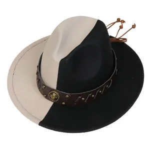 Detail of two-tone fedora hat featuring leather band with gold studs and metal emblem