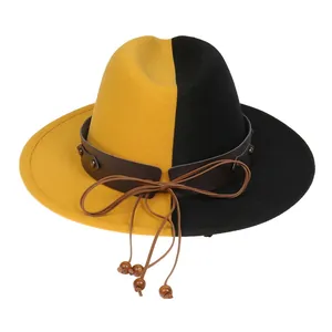 Detail of yellow and black bicolor wool fedora hat with studded leather band and wood beads
