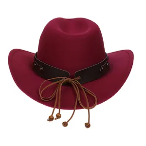 Detail of wine red cowboy hat featuring leather band with metallic studs and wooden beads