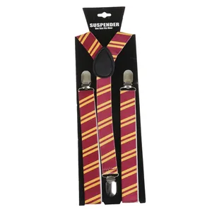 Detail of red and yellow striped elastic suspenders with silver metal clips and leather joint