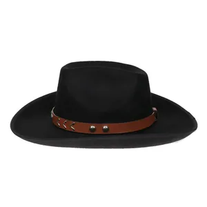 Detail of black wool felt cowboy hat featuring brown leather band with silver metal studs