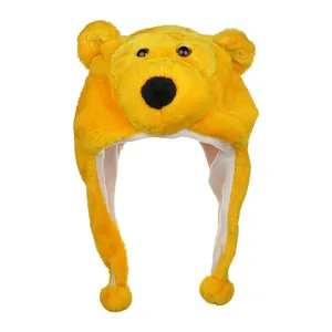 Detail of plush yellow cartoon bear hat with earflaps and soft pom-pom decorations