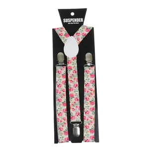 Detail of floral suspenders with pink rose pattern and silver metal clips on card