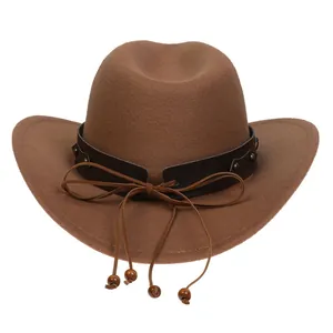 Detail of brown felt cowboy hat featuring leather band, rivets and wooden beads