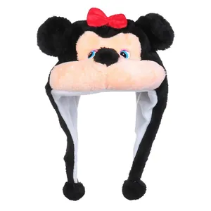 Detail of plush animal hat featuring black faux fur, red bow, and long earflaps with pompoms