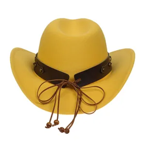 Detail of yellow cowboy hat with brown leather band, vintage metal studs and wood beads