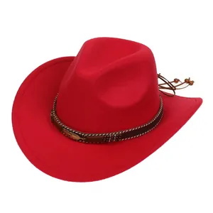 Close-up of bright red felt cowboy hat with gold feather metal buckle and beaded cord detail