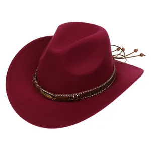 Detail of burgundy wool fedora with woven band, metallic feathers and beaded tassels