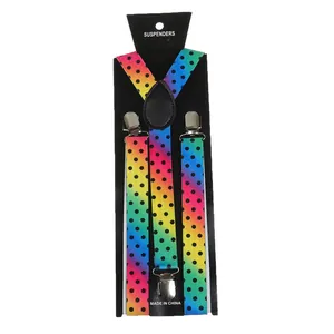 Close-up of rainbow gradient suspenders with black polka dots and metal clips